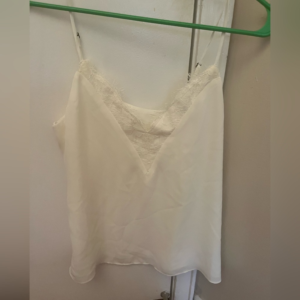 Off white tank top with lace trim around neckline. New with tags and never worn